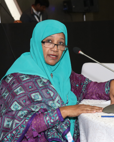 woman in blue talking at mic